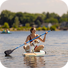 woman with dog on paddleboard